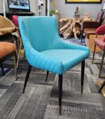 Teal color restaurant chair with black legs and gold caps